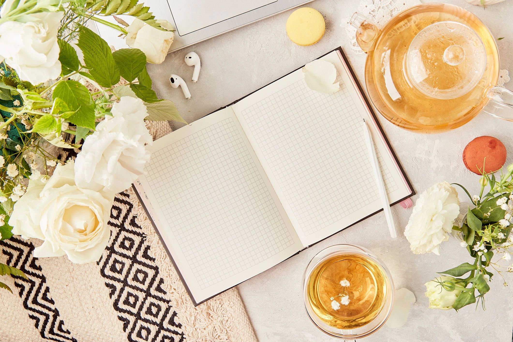 Cozy flat lay with skincare, journal, and herbal tea